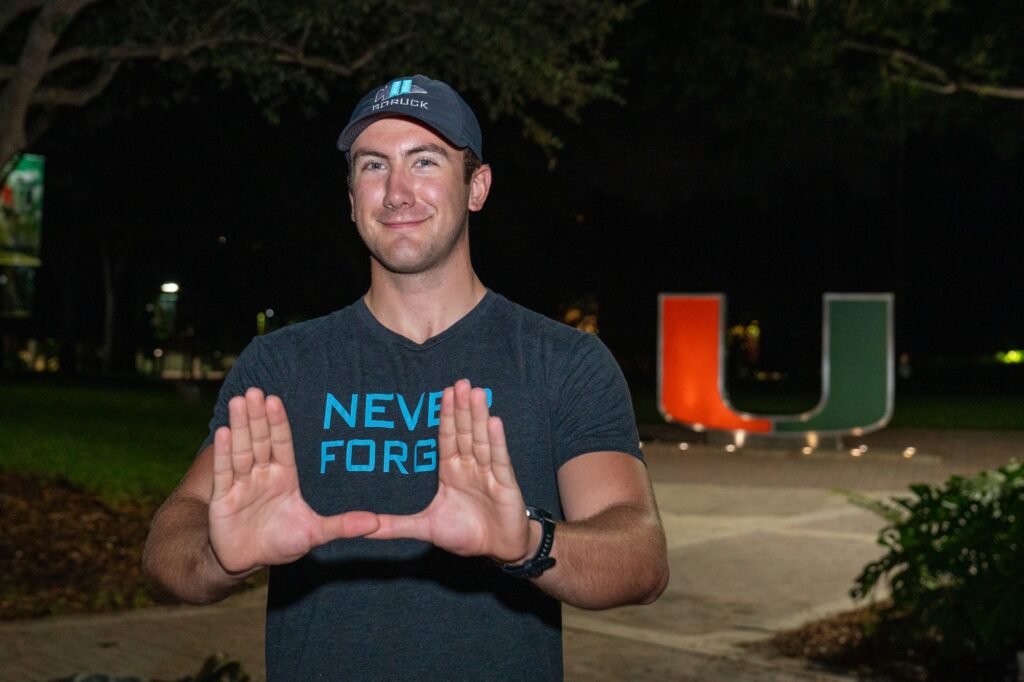 UM Ruck to Remember founder and organizer senior Alex Westover throws up the U ahead of the 9.11 mile memorial ruck on Sept. 11, 2023.