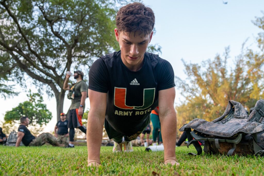 A member of the University of Miami Army ROTC completes a workout at the halfway point of the 9.11 mile memorial ruck at Tropical Park on Sept. 11, 2023.