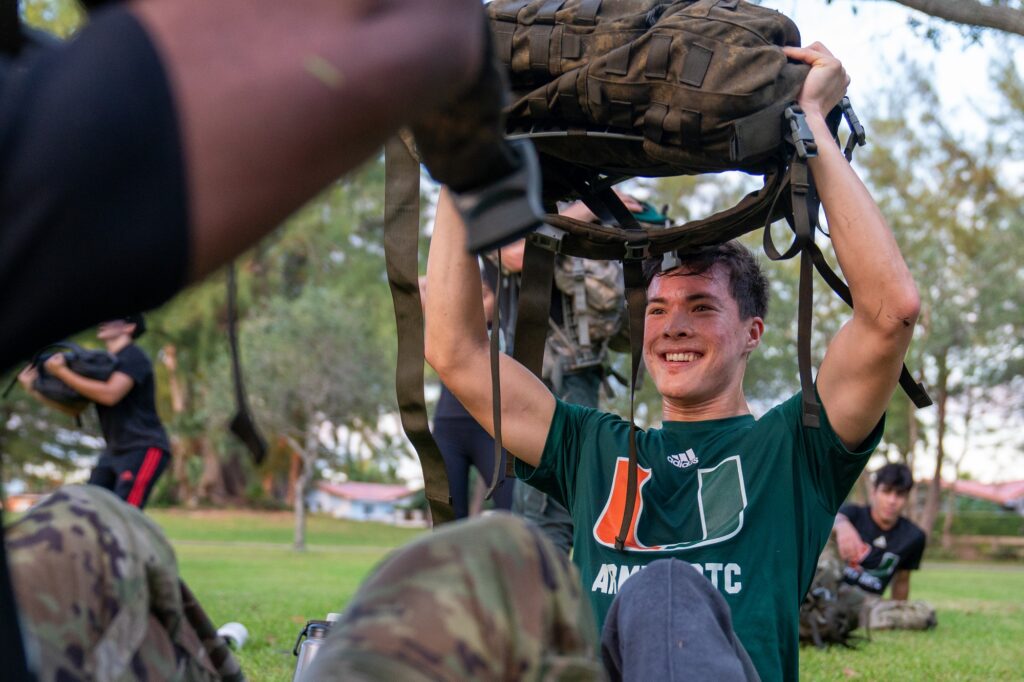 A member of the University of Miami Army ROTC completes a workout at the halfway point of the 9.11 mile memorial ruck at Tropical Park on Sept. 11, 2023.