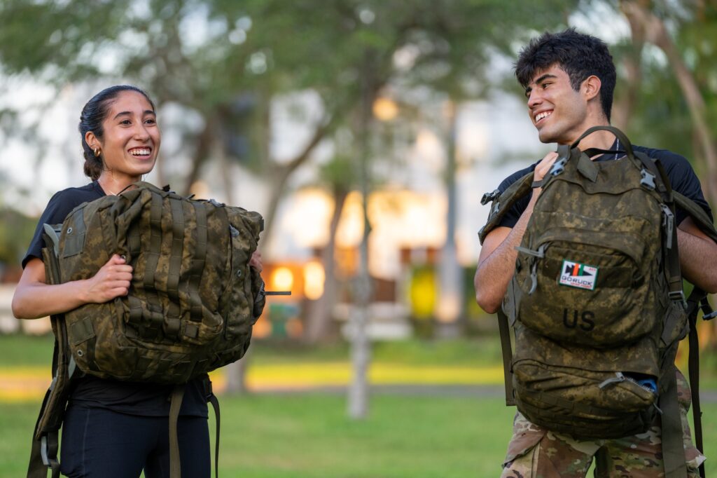 Participants do ruck-squats as a part of a workout at the halfway point of the 9.11 mile UM Ruck to Remember at Tropical Park on Sept. 11, 2023.