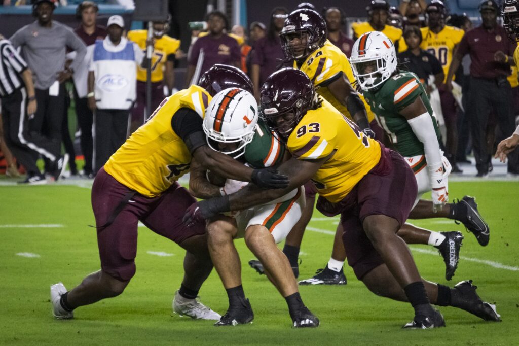 Early in the first quarter, fourth-year junior Xavier Restrepo rushes with two Bethune-Cookman defenders surrounding him during the ‘Canes’ 48-7 win.