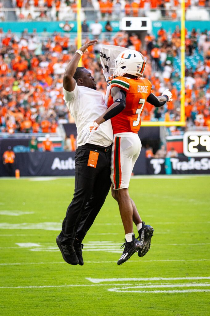 During the fourth quarter after making one of his three touchdowns, junior Jacolby George celerates with the wide receiver coach Kevin Beard during the win against Texas A&M.