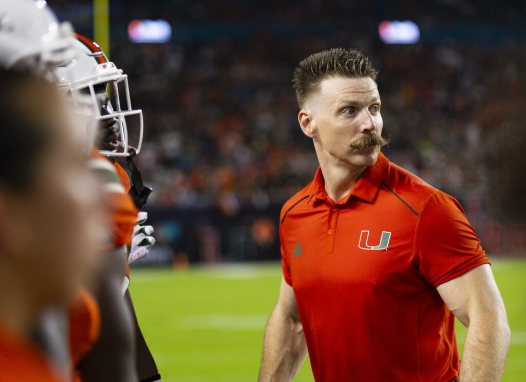 Miami Hurricanes Football Strength & Conditioning Coordinator Aaron Feld eagerly watches Miami's game against Miami University (OH) at Hard Rock Stadium on Sept. 1, 2023.