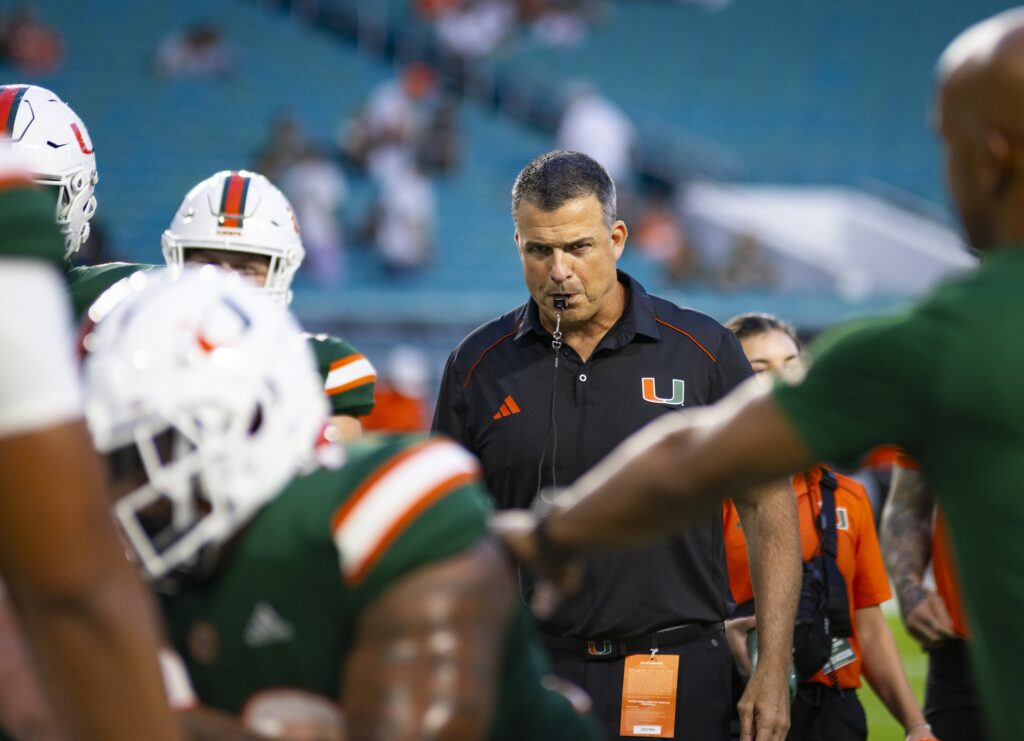 Miami football head coach Mario Cristobal guides players through warm-up drills before their game against Bethune-Cookman at Hard Rock Stadium on Sept. 14, 2023.