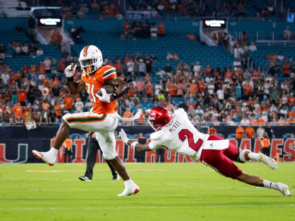 Junior running back Henry Parrish, Jr. evades Miami University corner back Yahsyn McKee to score a 12-yard rushing touchdown in the fourth quarter of the season opener. credit: Charisma Jones