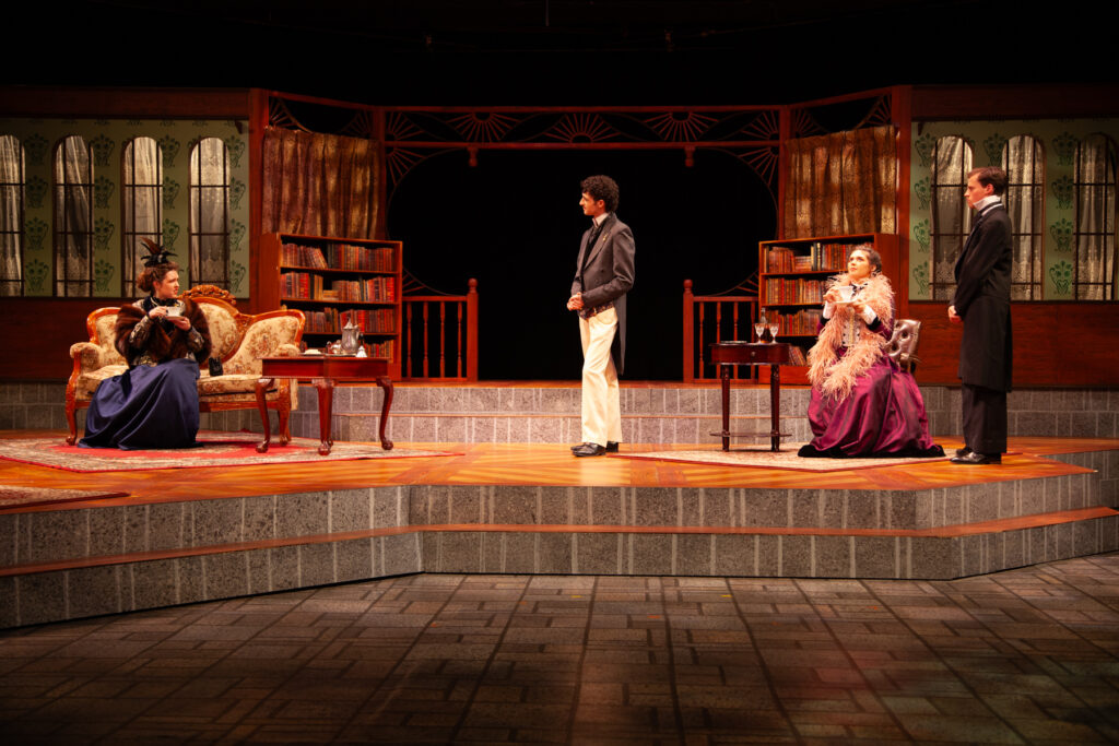 On the left: Algernon Moncrieff (Owen Trawick, center left), Lady Bracknell (Josephine
Dinan, far left), Jack Worthing (Keenan Lyons, far right) and Gwendolen Fairfax (Dominique
Karanfilian, center right) perform in the UM production of “The Importance of Being
Earnest” in the Jerry Herman Ring Theatre on Oct. 4, 2023.