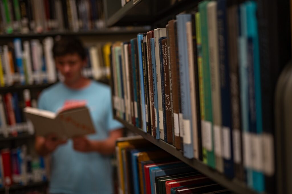 UM student Kyle Somelofske browsing through books in the Richter Library.
