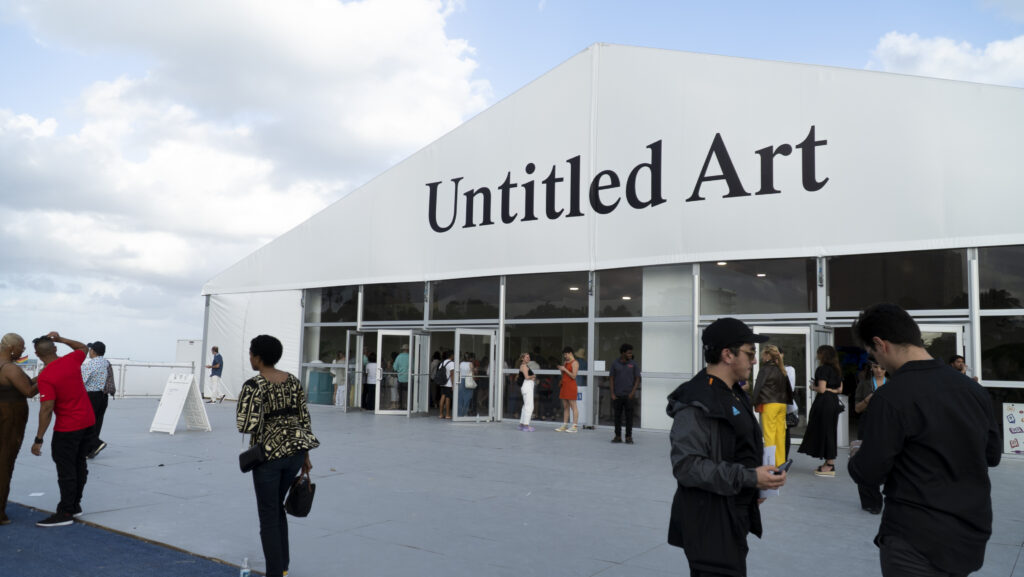 Visitors gather outside the entrance to the Untitled Art fair during Miami Art Week 2022.