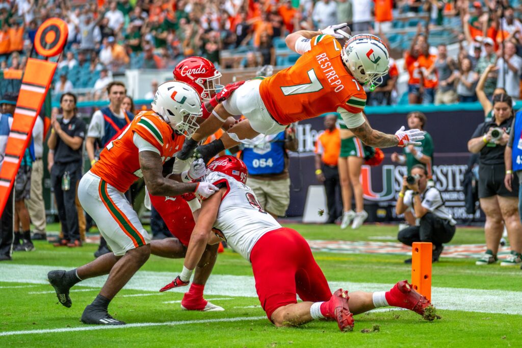Fourth-year junior wide receiver Xavier Restrepo dives into the end zone for a touchdown in the first quarter of Miami’s game versus Louisville at Hard Rock Stadium on Nov. 18, 2023.