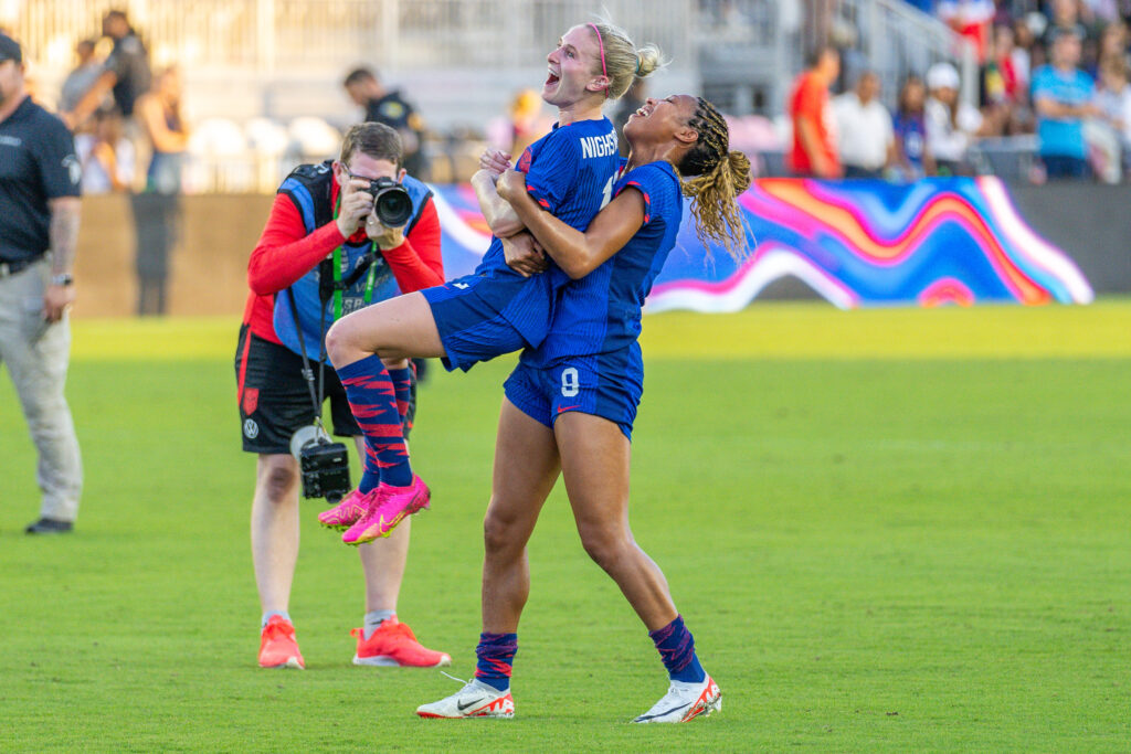Forward Midge Purce lifts midfielder Jenna Nighswonger in celebration of her first appearance after the USWNT’s 3-0 win over China PR at DRV PNK Stadium on Dec. 2, 2023.