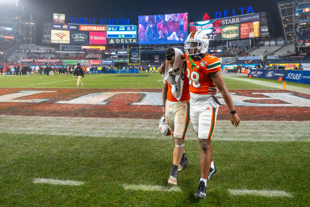 Fourth-year junior wide receiver Xavier Restrepo and redshirt freshman Myles Mooyoung leave the field following Miami's 24-31 Pinstripe Bowl loss to Rutgers at Yankee Stadium on Dec. 28, 2023.