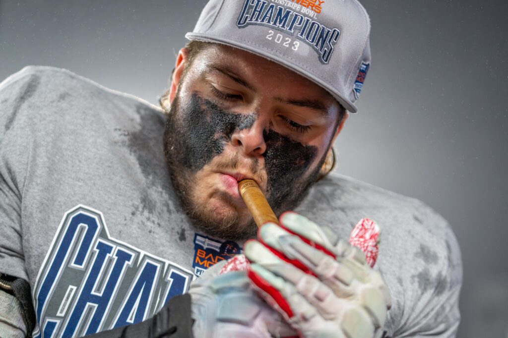 A Rutgers player lights a cigar after beating Miami 31-24 in the Pinstripe Bowl at Yankee Stadium on Dec. 28, 2023.