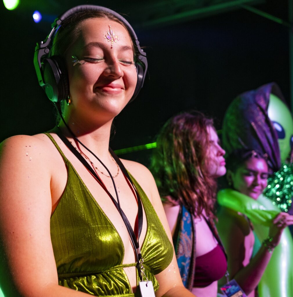 EQ Collective President DJ Gr33n Juic3 smiles during her set at the Afterglow Music & Arts Festival on Saturday, April 29, at the Foote Green.
