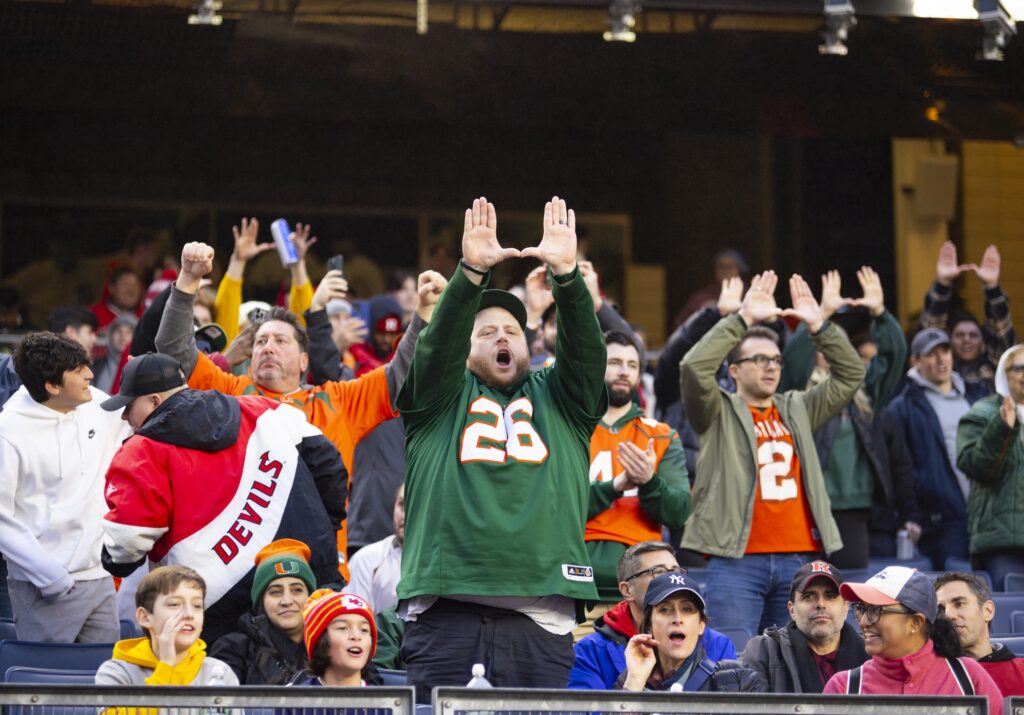 'Canes fans stand and hold up the U during Miami's Pinstripe Bowl game against Rutgers at Yankee Stadium on Dec. 28, 2023.