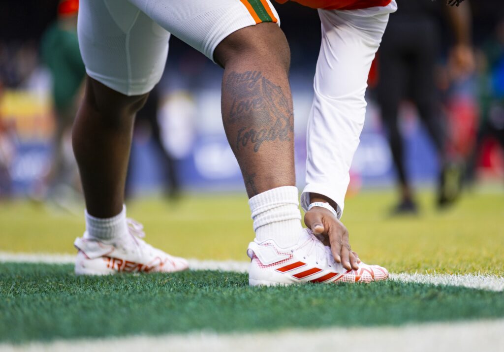 A 'Canes player stretches during warmups ahead of Miami's Pinstripe Bowl matchup versus Rutgers at Yankee Stadium on Dec. 28, 2023.