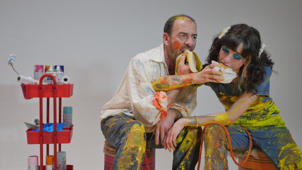 The artist (Dimiter D. Marinov) and his muse (Carl Nowak) eat while tied to each other with a rope during the filming of “COLLAGE.”