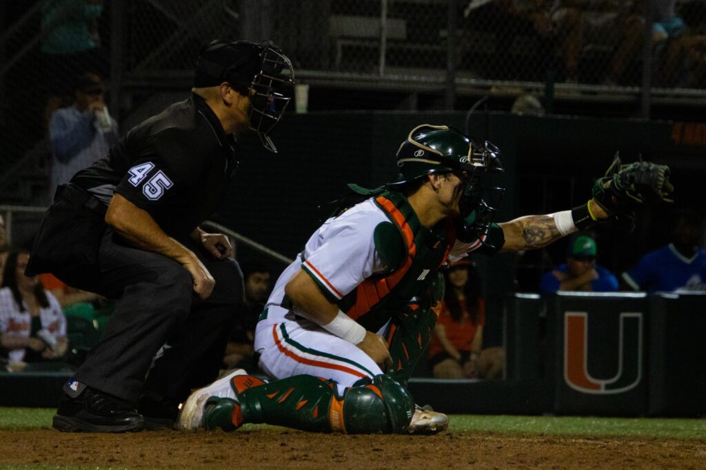 Senior catcher Carlos Perez recieves a pitch against FGCU at Alex Rodriguez Park at Mark Light Field on Wednesday, Feb. 28, 2024.