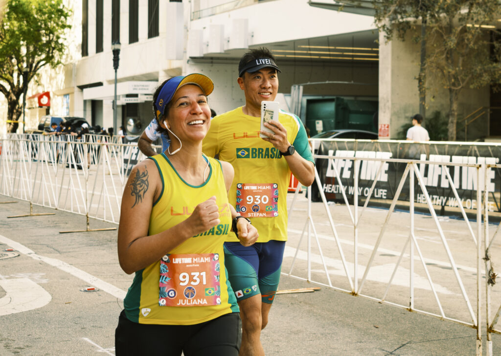 Miami Marathon participants smile as they approach the finish line on Jan. 28, 2024.