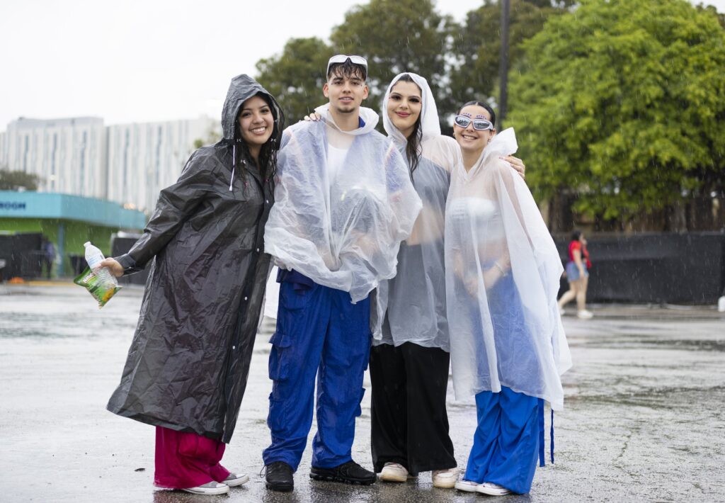 Vibra Urbana attendees brave the rainstorms that ultimately lead to evacuation and performance delays on Sunday, Feb. 18, 2024, at the Miami-Dade County Fair and Exposition Center.